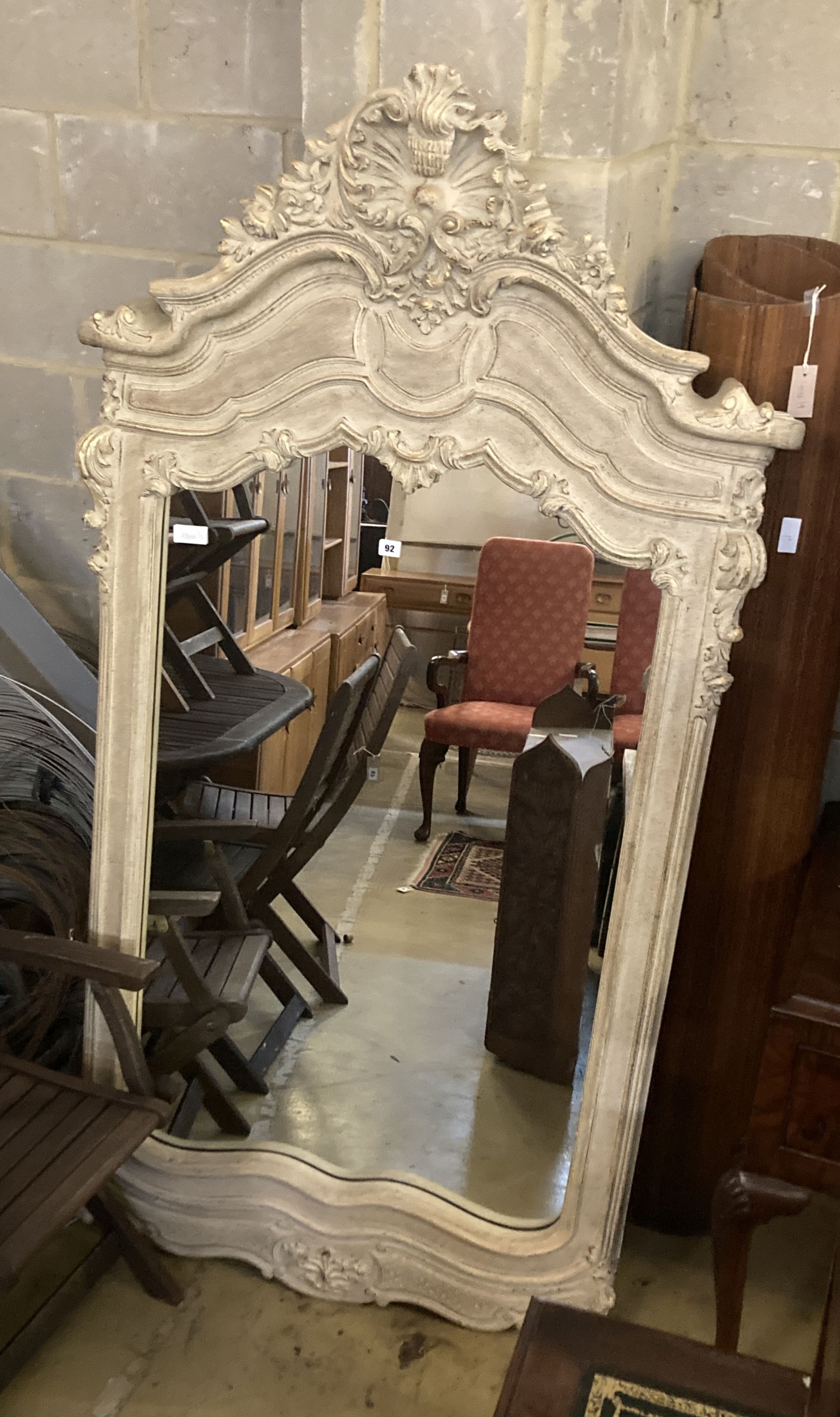 A composition rococo style overmantel mirror, width 100cm height 194cm